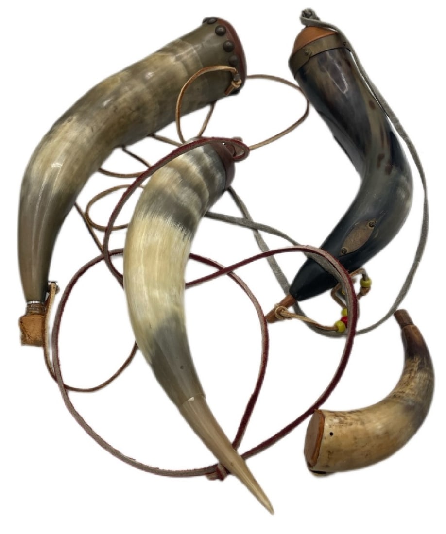 Assortment Of Handcrafted Powder Horns: Assortment Of Handcrafted Powder Horns. These all appear to be in nice, used condition. Powder horns were often used with black powder muzzleloaders. They all come with a leather shoulder carrier.