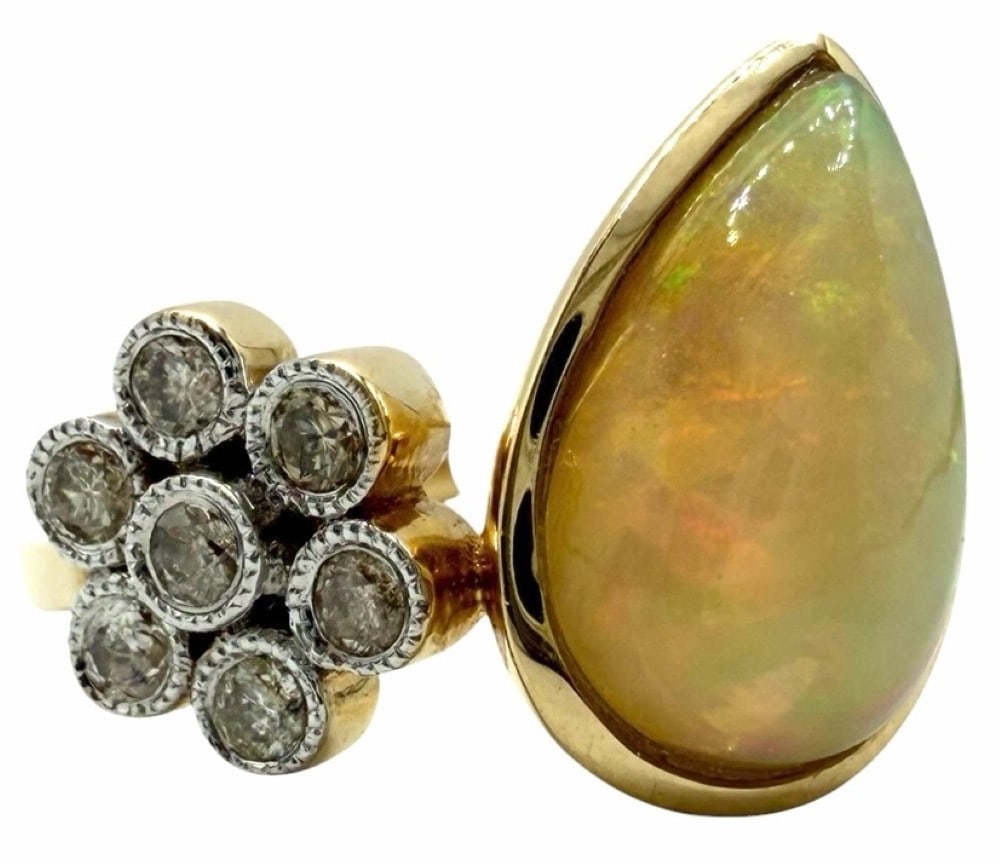 14K Yellow Gold 1.87ctw Diamond and Opal Ring, Size 7: 14K Yellow Gold 1.87ctw Diamond and Opal Ring, Size 7.? This beautiful ring has one center natural pear cut opal set in bezel setting style and weighs 1.68ct.? The ring is accented with a total of 7 r