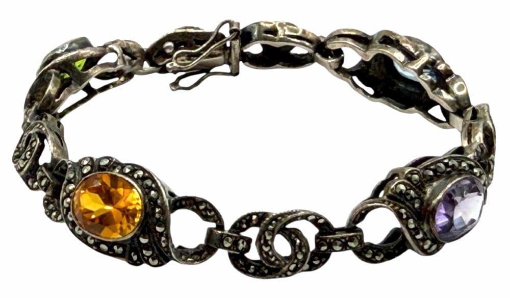 Vintage Sterling Silver Marcasite Multi-Stone Filigree Bracelet: Vintage Sterling Silver Marcasite Multi-Stone Filigree Bracelet.? This beautiful bracelet contains Oval cut Emerald, Purple Amethyst, Blue Topaz and Yellow Sapphire.? Clasp is marked 925 and bracelet