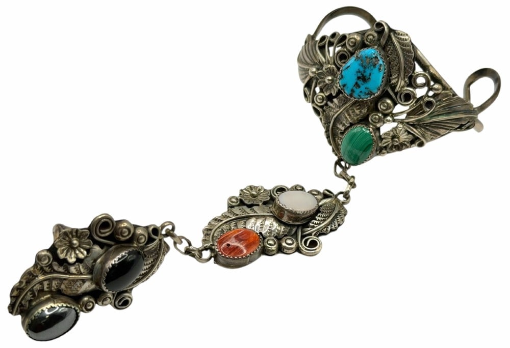 Harry B Yazzie Sterling Silver Navajo Slave Bracelet: Harry B Yazzie Sterling Silver Navajo Slave Bracelet. Engraved on the middle piece is STERLING HBY. Includes turquoise, mother of pearl, black onyx and other stones. Measures 2.5in x 2in x 1.75in with