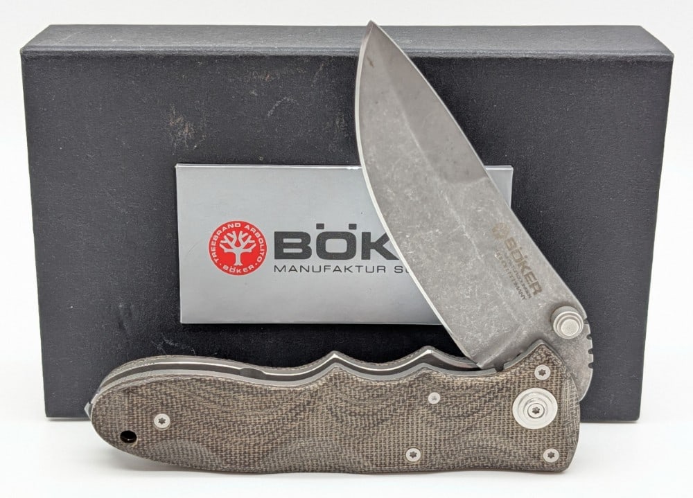 Boker Titan Defender Folding Knife w/ Box: Features a gray stonewash finish blade, and ergonomic canvas micarta handle scales with steel liners. Knife is in very nice condition with light scuffs from handling. Overall measures 4-5/8in when clo