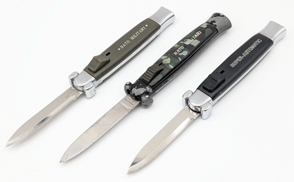(3) NATO Military OTF Automatic Knives: Knives are in good condition with some scuffs and finish wear on the handles. Overall measures 4-3/4in when closed.