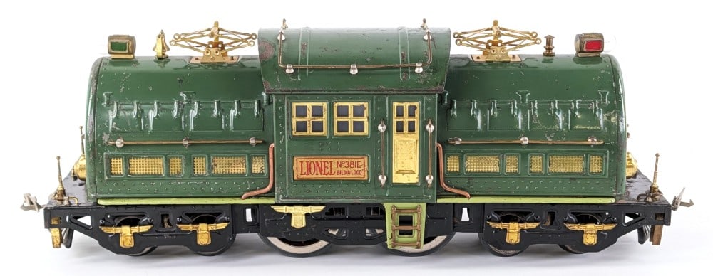 Lionel Standard Gauge 381E Green Electric Locomotive: Prewar Lionel standard gauge 381E green electric locomotive. The locomotive has paint loss, crazing, and wear from use and age.
