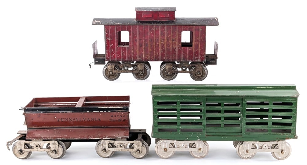 Lionel Standard Gauge 13 Stock Car, 16 Ballast Car, 17 Caboose: Prewar Lionel standard gauge 13 stock car with embossed bottom, 16 Pennsylvania 65784 ballast car, and 17 NYC & HRRR caboose with embossed bottom. The cars show a good amount of paint loss and wear fr