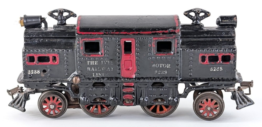 Ives O Gauge 3238 Electric Locomotive: Prewar cast iron Ives O Gauge 3238 electric locomotive black with red trim. Shows paint loss and wear from use and age.
