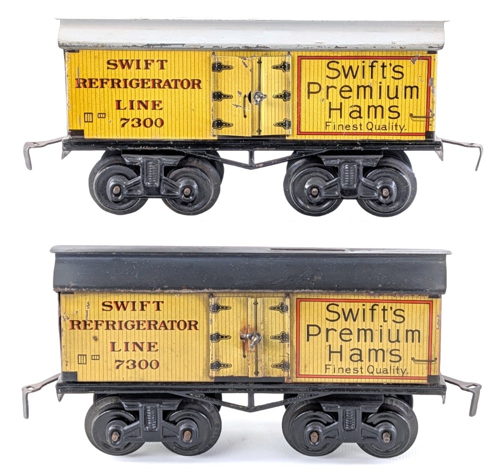 (2) Bing Swift's Premium Hams Refrigerator Line 7300 Reefer Cars: (2) Bing Swift's Premium Hams Refrigerator Line 7300 reefer cars. The one car has an unusual coin slot on the roof. Both show some scratches and wear from age. Each car measures approximately 6-1/2"