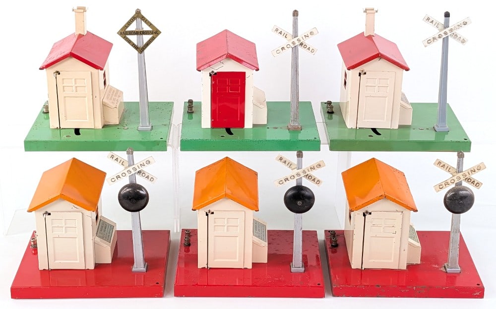 (3) Lionel No. 76 Warning Bell and Shack and (3) No. 45 Automatic Gateman: (3) Lionel No. 76 warning bell and shack plus (3) No. 45 automatic gateman. All are showing paint loss and wear from use and age.