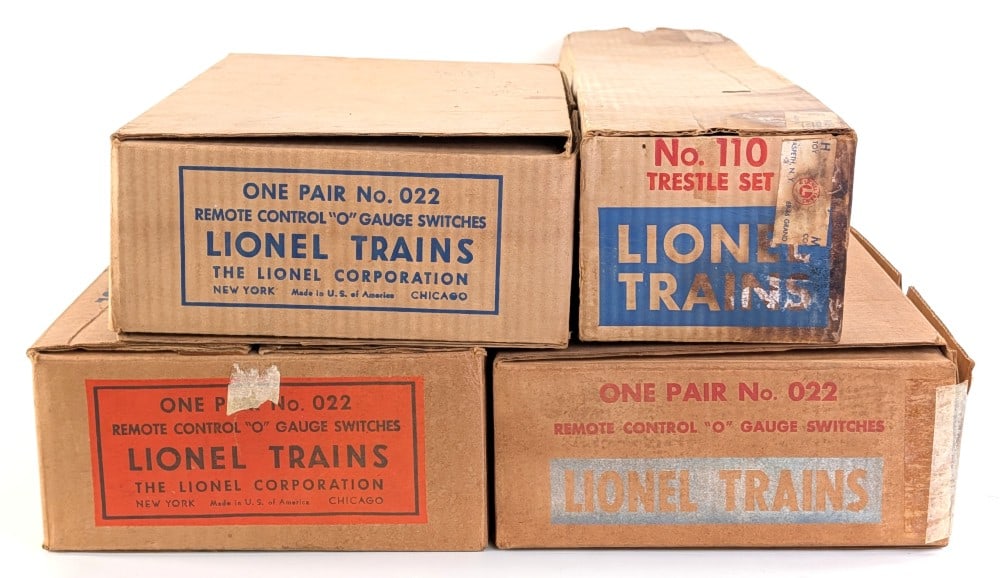 (3) Lionel No. 022 Switches and No. 110 Trestle Set In Boxes: Includes (3) Lionel No. 022 O Gauge switches and No. 110 trestle set. The boxes for the switches are all different variations. The boxes for the switches all have the inserts. The trestle set box has 