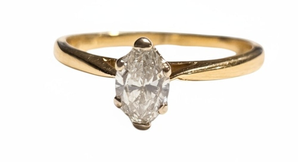 14kt Yellow Gold Marquise Diamond Ring: The diamond is set in a white gold six prong basket style head. The ring is a size 9. The diamond is .58cts.? The ring weighs 2.44 grams.? ?