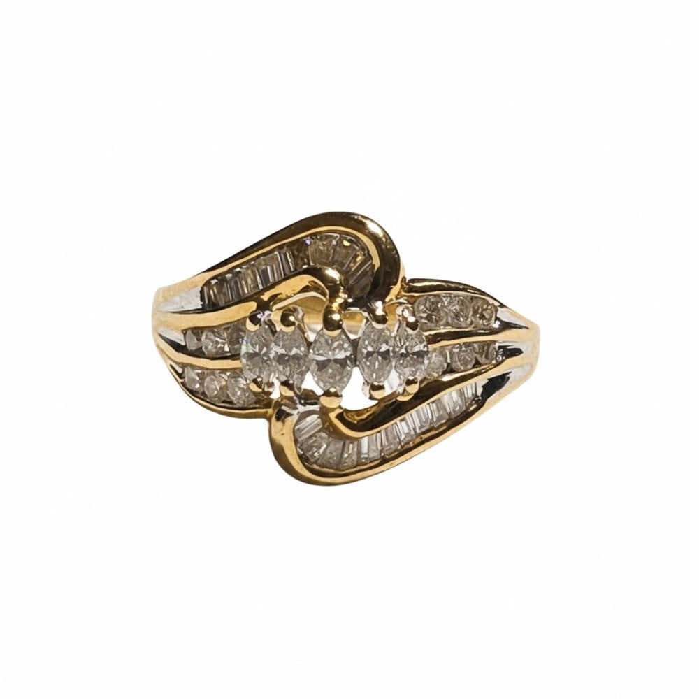 14kt Yellow Gold Baguette and Marquise Diamond Ring: The ring contains 39 diamonds. The (5) marguise diamonds are each set with two 14k yellow gold prongs. The round and baguette cut diamonds are all channel set. Total diamond weight 1ct. The ring is a