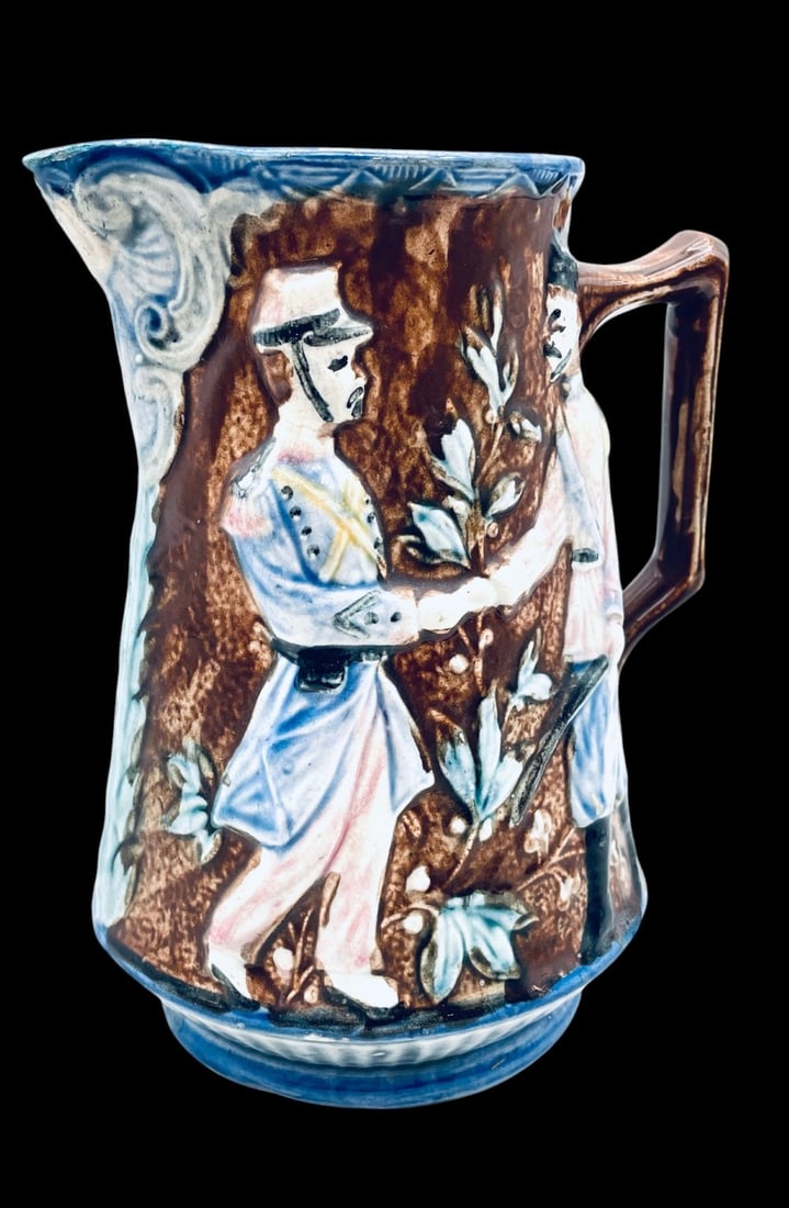 Antique Ceramic Majolica Pitcher: Antique Ceramic Majolica Pitcher. Majolica Pitcher is in overall good condition with chips on edge. Measures 8 1/2