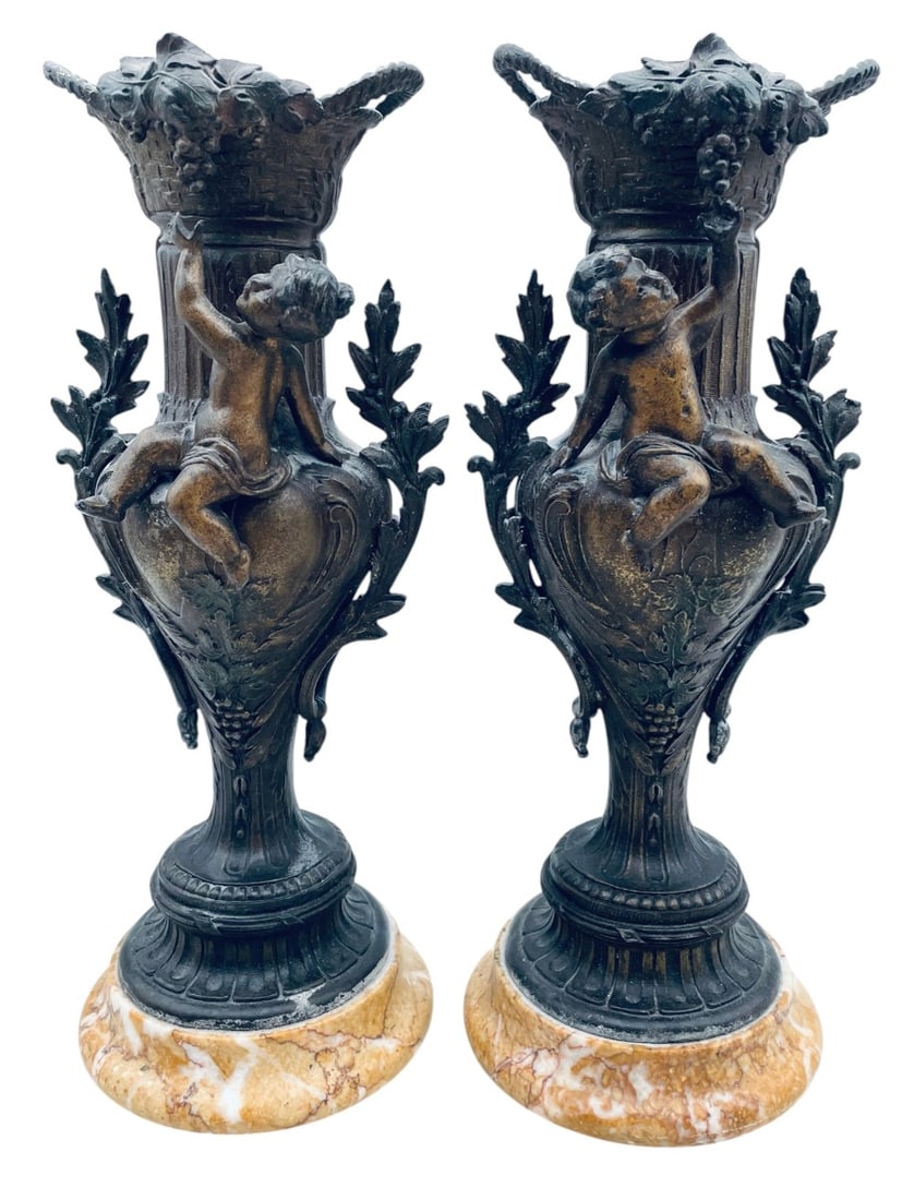 2 French Spelter Metal Cherub Vases: 2 French Spelter Metal Cherub Vases. Cases are in overall good condition with Marble Bases with Grapes. Measures 14? tall
