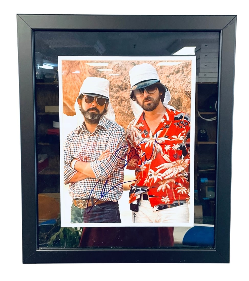 George Lucas and Steven Spielberg Signed Photograph: George Lucas and Steven Spielberg Signed Photograph. Photograph is Signed in Blue Marker and is authenticated Todd Mueller.17? x 20