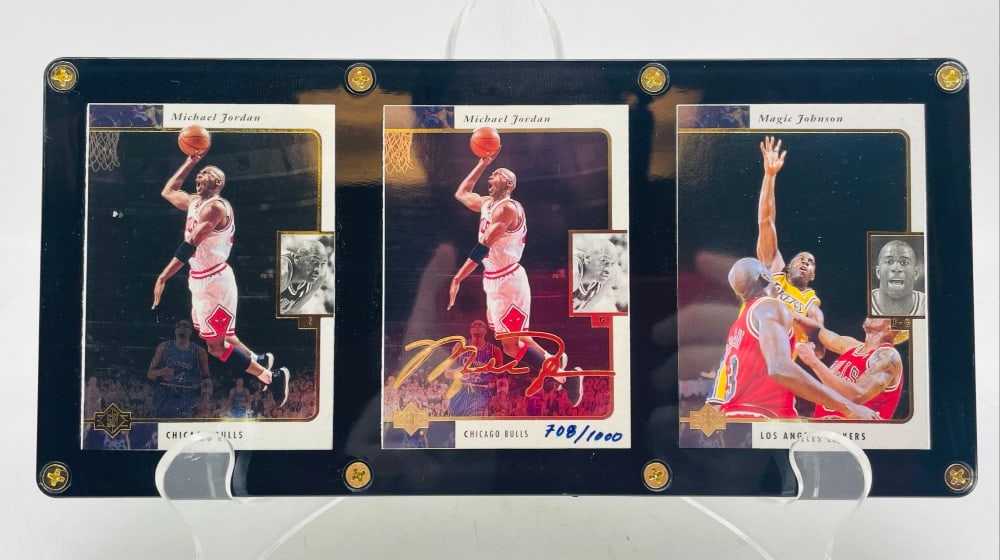 (3) 1996 Upper Deck Michael Jordan Cards: (3) 1996 Upper Deck Michael Jordan Cards. Michael Jordan #23 and Gold Auto #ED 708/1000 and Magic Johnson #66 with M.J. Cards have some Edge-Ware