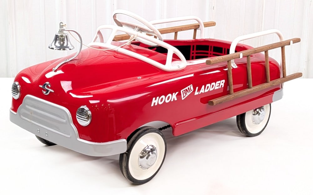 Restored BMC Hook and Ladder Fire Truck Chain Drive Pedal Car: Professionally restored chain drive BMC hook and ladder fire truck pedal car. The car features a chrome bell, two wood ladders, chrome hubcaps, and a nice restoration. Overall good condition with a co