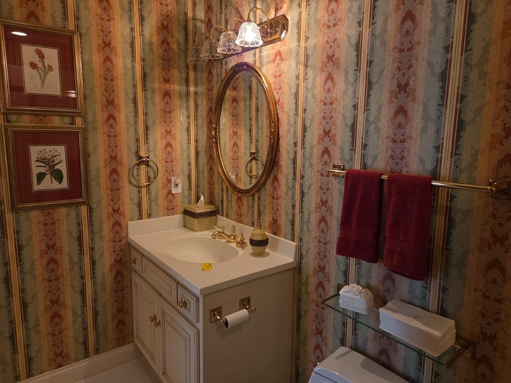 Contents Of Bathroom Include Towels, Framed Prints, Mirror, & More (1 of 6)