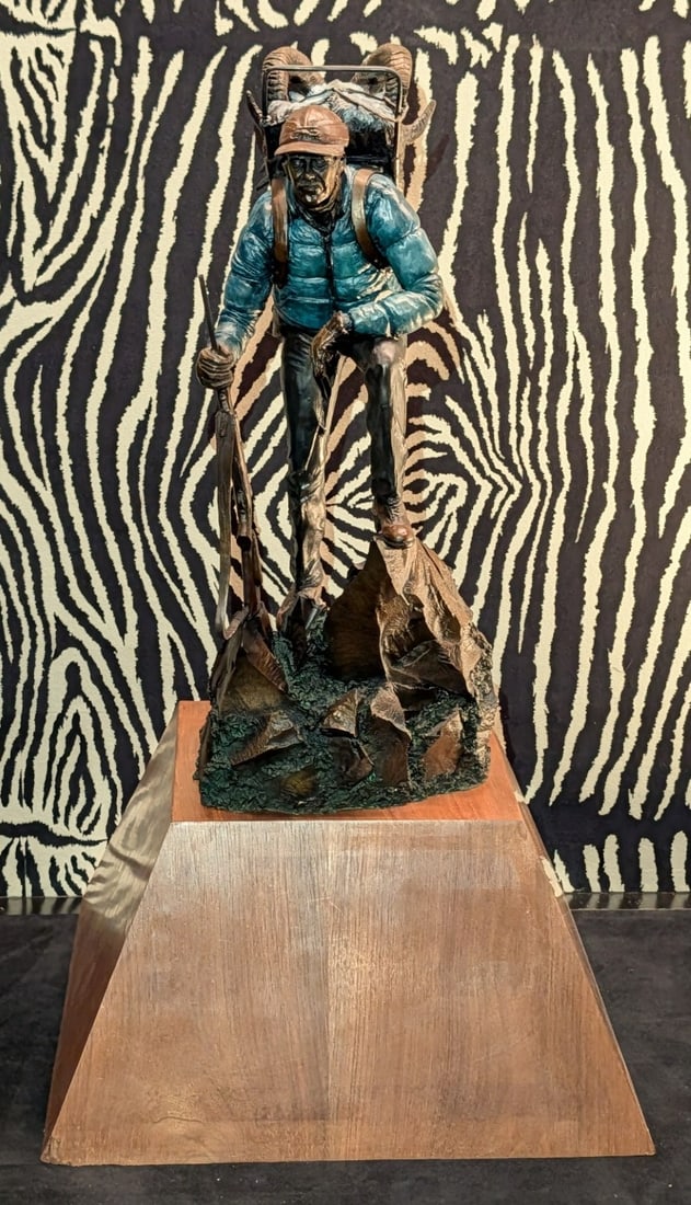 1998 Fred Boyer Backpacking Hunter Cold Painted Bronze Sculpture: 1998 Fred Boyer Backpacking Hunter Cold Painted Bronze Sculpture. A gorgeous piece with two ram skins in the hunters pack cold painted with great details.?Measures 13-1/4in across x 13-3/4in deep x 24