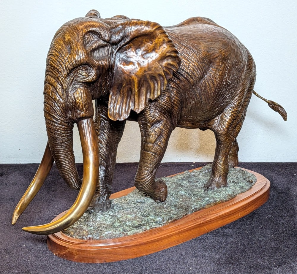 1999 Ltd. Bronze Elephant Sculpture by D. Schaefer: 1999 Ltd. Bronze Elephant Sculpture by D. Schaefer. Piece is numbered 21/27. A very large bronze with bright polished tusks, tons of details on the body, and more details on the base. An extremely imp