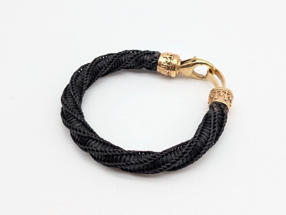 Finely Woven African Elephant Hair Bangle Bracelet US RESIDENTS ONLY: Finely Woven African Elephant Hair Bangle Bracelet US RESIDENTS ONLY. Features a very tightly woven pattern with a twisting design. The clasps are gold in color, but are not marked. Approx size 7