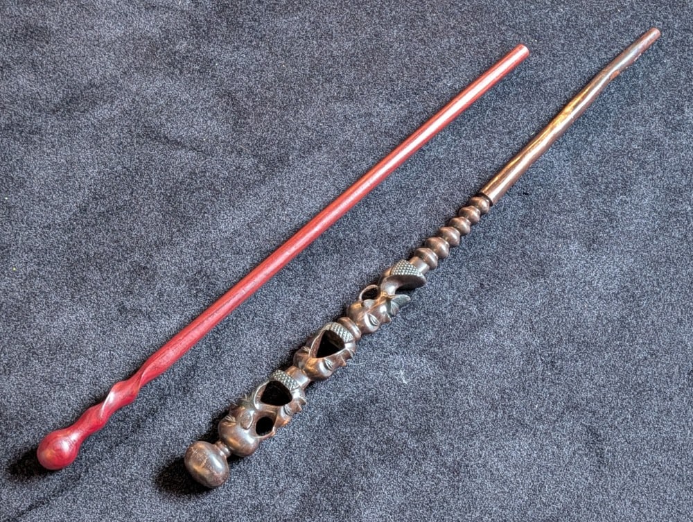 (2) African Carved Wood Walking Sticks: (2) African Carved Wood Walking Sticks. One is possible made from African ironwood with carved tribal faces. Both are in very nice condition with little to no wear. Measures 38-1/2in long.
