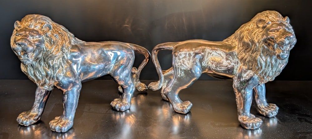 (2) Silver Plate Lion Statues: (2) Silver Plate Lion Statues. Statues are in very nice condition with general tarnishing from age. Measures 15in long.