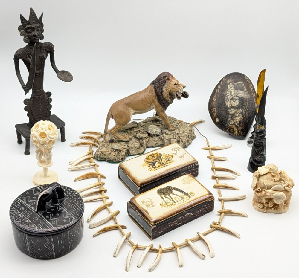 African Decorative Pieces: African Decorative Pieces. Includes a bone necklace, figures, trinket boxes, and more. Largest measures 10in tall.