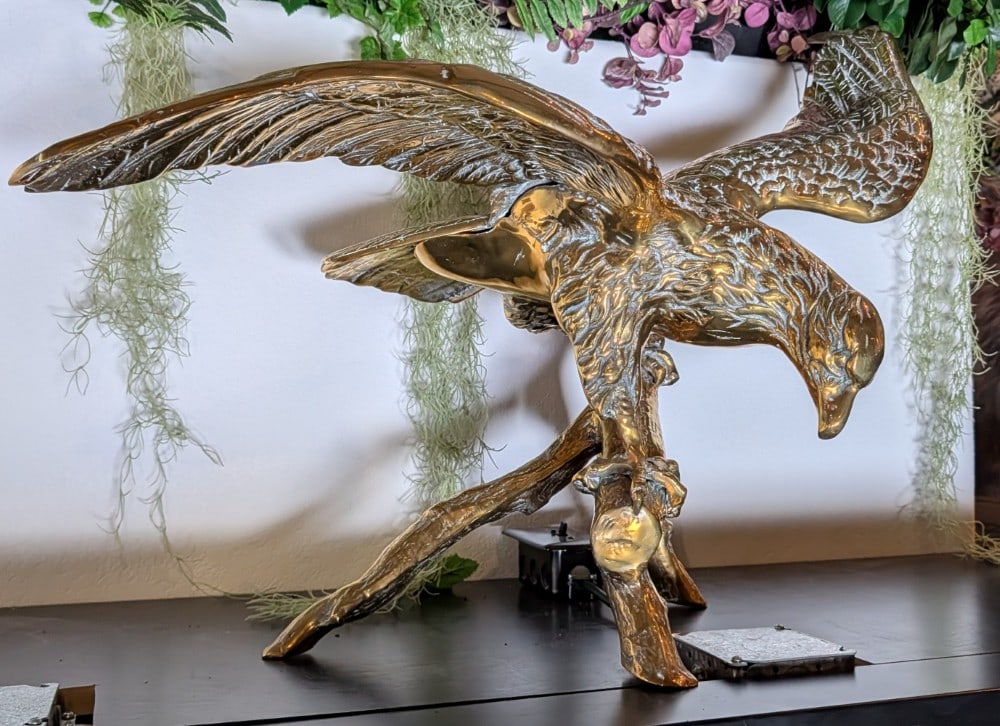 Polished Brass Eagle Sculpture: Polished Brass Eagle Sculpture. Piece is in very nice condition with some tarnishing from age. Measures 32in wide x 17in deep x 23in tall.