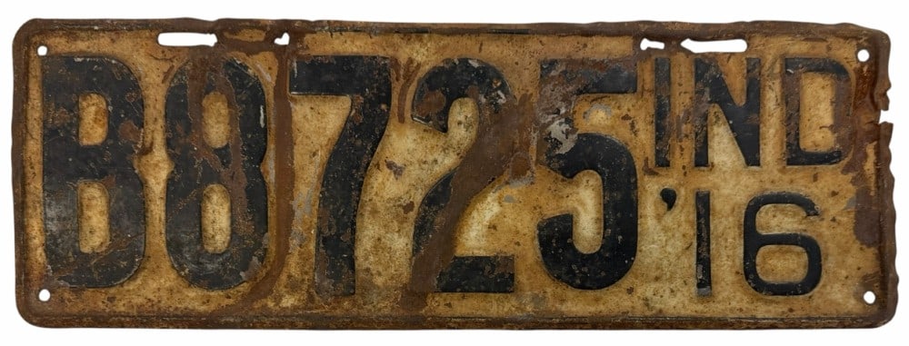 1916 Indiana Vehicle License Plate: 1916 Indiana Vehicle License Plate. This vintage license plate has visible signs of wear and rust due to age. Despite the wear the lettering remains legible. This plate measures approximately 16" by 5