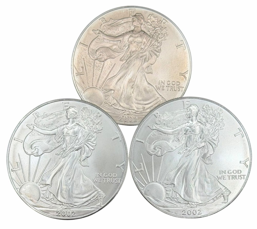 (3) 2001 United States Silver American Eagle One Ounce .999 Fine Silver Dollars, Uncirculated: (3) 2002 United States Silver American Eagle One Ounce .999 Fine Silver Dollars, these coins are uncirculated. ?Total weight 3 troy ounces of .999 fine silver