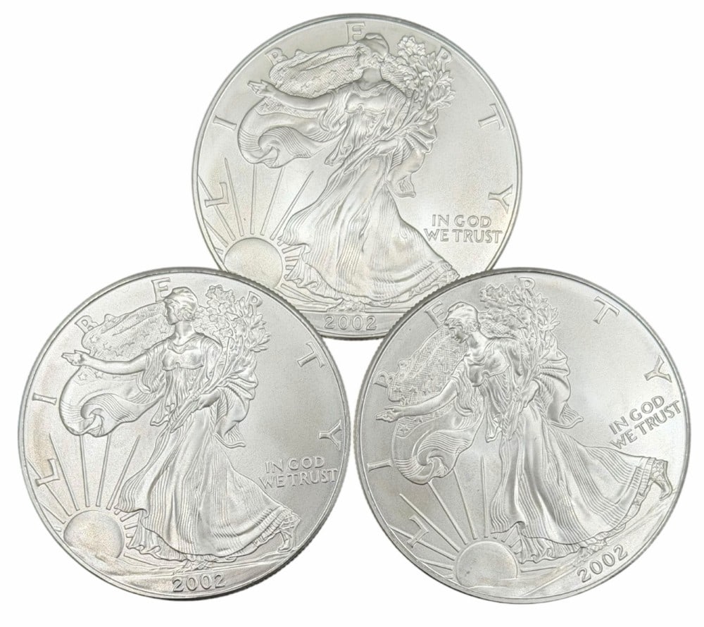 (3) 2001 United States Silver American Eagle One Ounce .999 Fine Silver Dollars, Uncirculated: (3) 2002 United States Silver American Eagle One Ounce .999 Fine Silver Dollars, these coins are uncirculated. ?Total weight 3 troy ounces of .999 fine silver