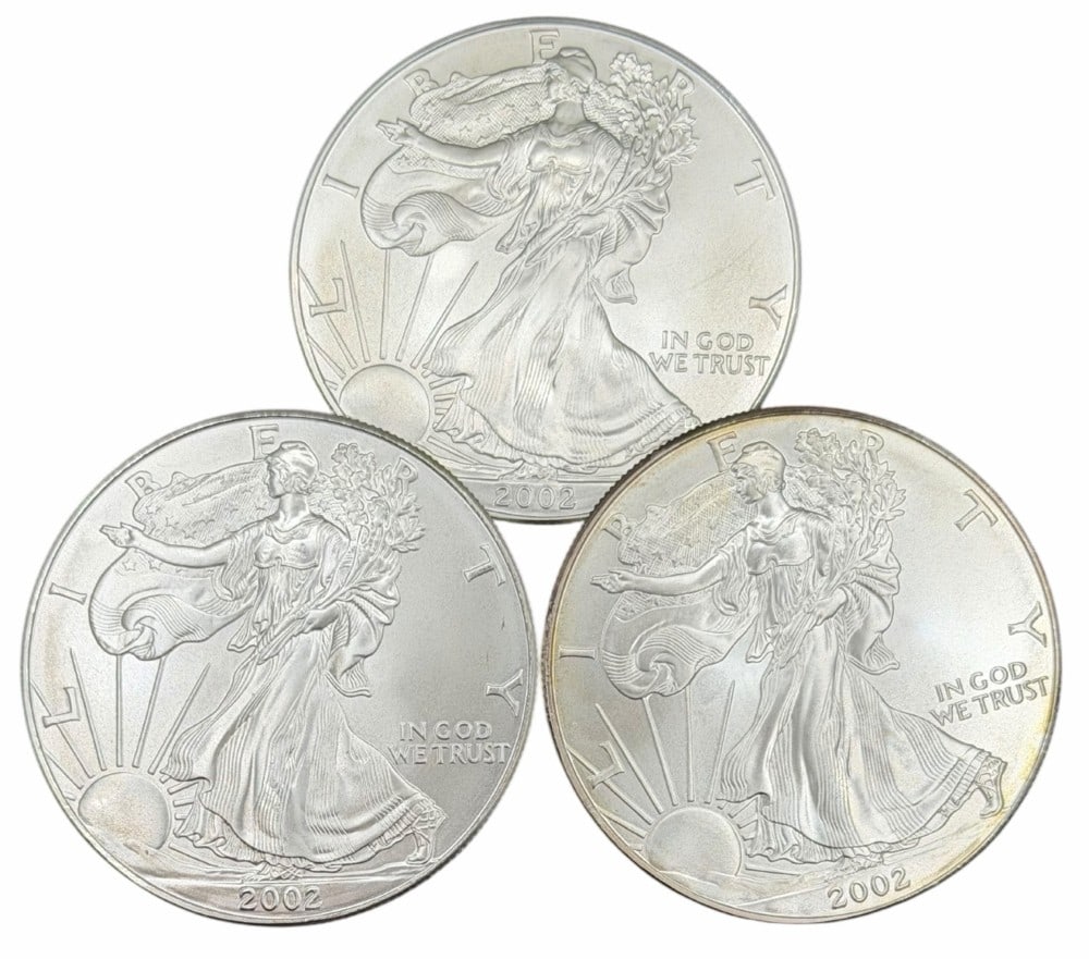 (3) 2001 United States Silver American Eagle One Ounce .999 Fine Silver Dollars, Uncirculated: (3) 2002 United States Silver American Eagle One Ounce .999 Fine Silver Dollars, these coins are uncirculated. ?Total weight 3 troy ounces of .999 fine silver