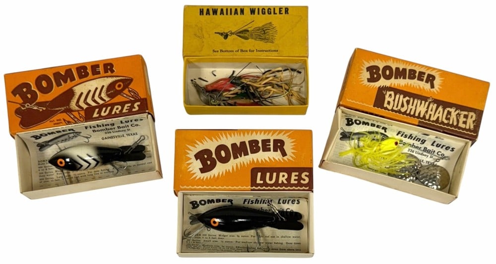 Three Bomber Bait Co. Lures And Hawaiian Wiggler Lure w/ Boxes: Three Bomber Bait Co. Lures And Hawaiian Wiggler Lure w/ Boxes. Included are three various Bomber Bait Co Lures from Gainesville, Texas. There are two Bomber Style lures and one Bushwhacker lure. Also