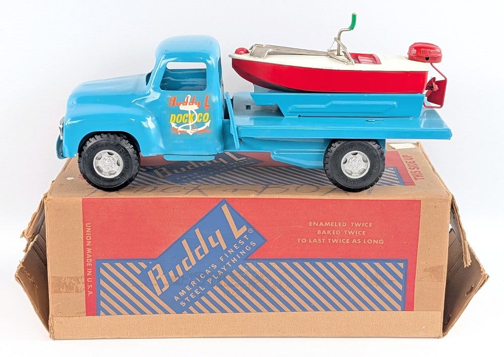 Buddy L No. 5526 Boat Transport Truck w/ Box: Original Buddy L No. 5526 boat transport truck with the original box. The truck is in excellent condition overall with some minor rub marks and minor scratches from the boat. The passenger side door d