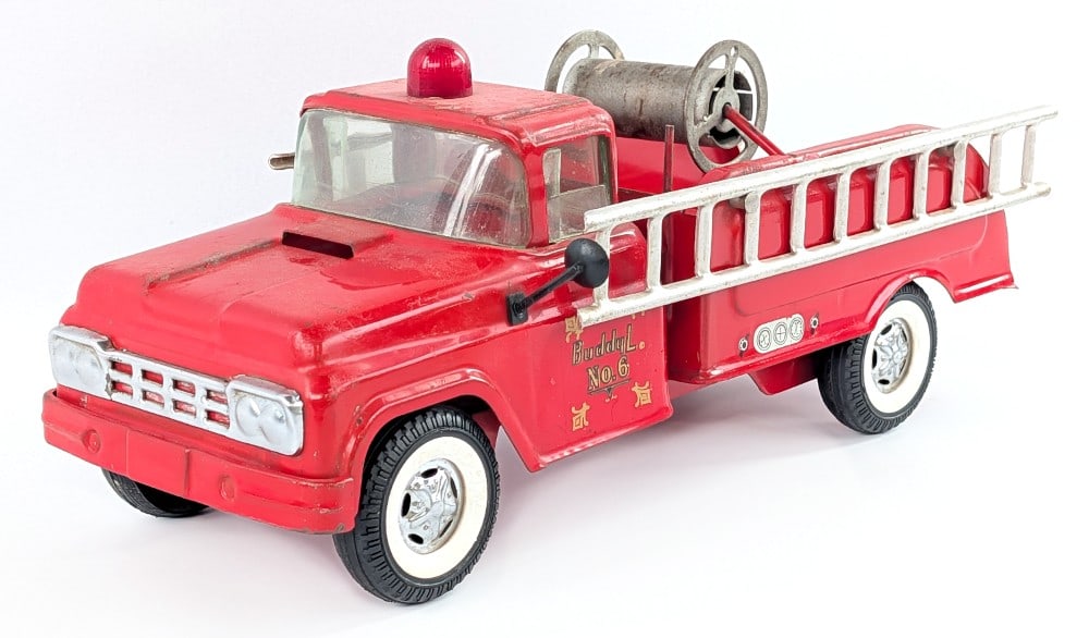 Buddy L No. 6 Fire Truck: Original Buddy L No. 6 fire ladder truck. The truck has paint loss, surface rust, and wear from play and age. It is missing the hose for the hose reel and lightbar. Measures approximately 14-1/2" long