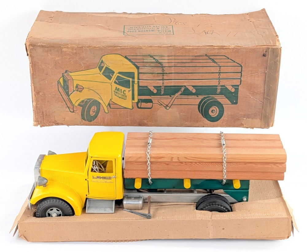 Smith Miller #538 Lumber Truck w/ Box: Original Smith Miller #538 lumber truck with the original box. The truck is in excellent condition overall. The box has some water damage, discoloration, and writing. It comes with the cardboard