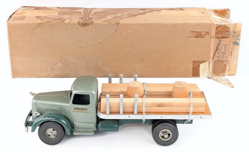 Smith Miller L Mack Material Truck: Smith Miller L Mack material truck. The truck comes with a newer replacement load. It comes with an unmarked box that has water staining and tape on the open end. The truck has some paint chips and