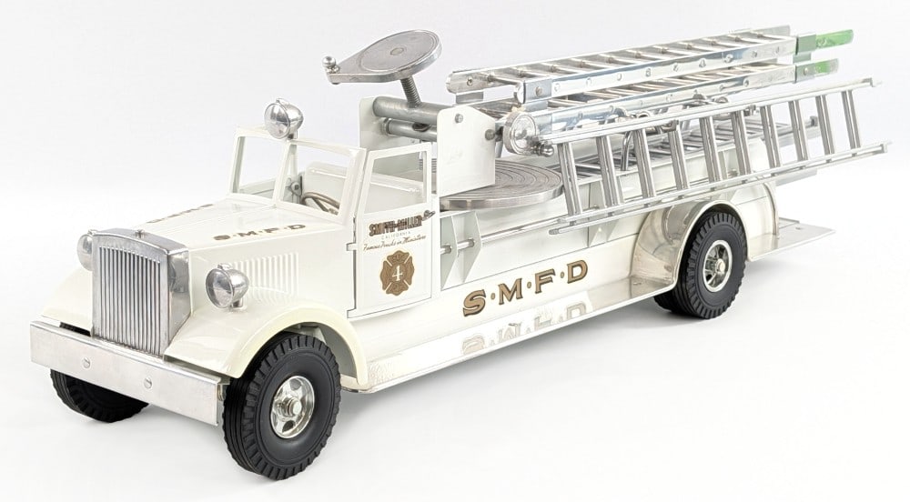 Fred Thompson Smith Miller MIC SMFD Aerial Ladder Truck - White: Fred Thompson Smith Miller MIC "Smith Miller Fire Department" aerial ladder fire truck. MIC open cab in white variation. Displays well with chrome aerial ladder, chrome extension ladders, and siren. T