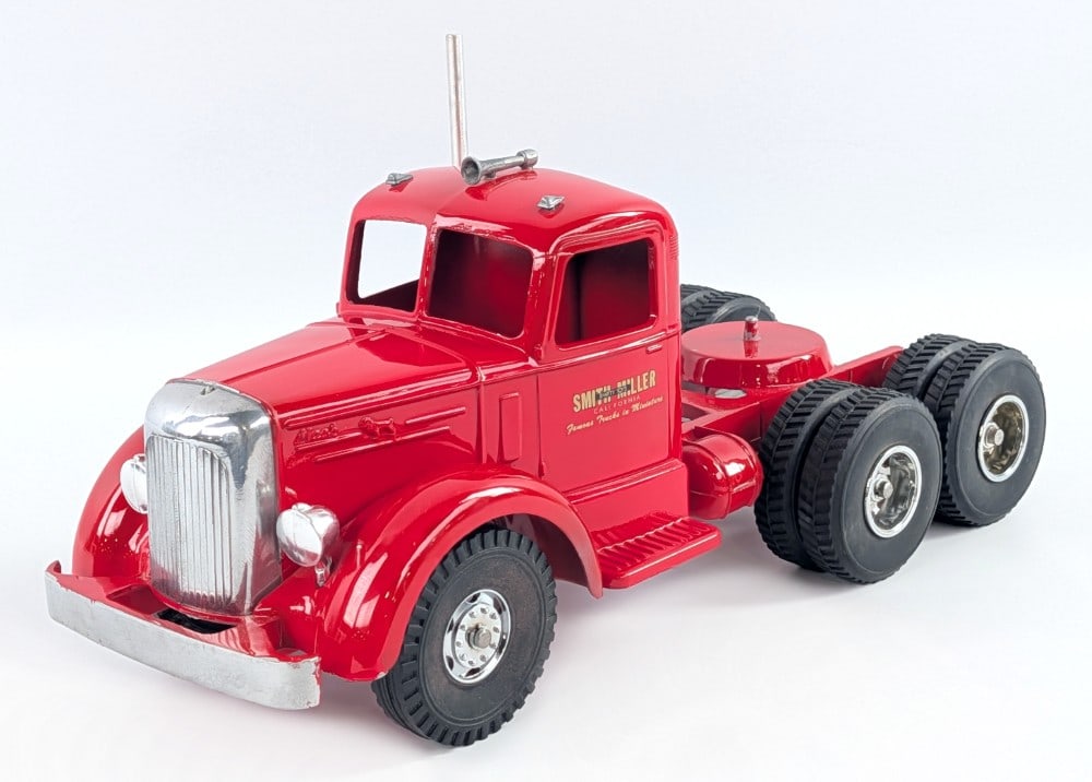 Custom Smith Miller L Mack Truck: Custom Smith Miller L Mack truck. The truck has tandem axles, custom wheels, and chrome features. It is missing the hood ornament. Good condition with a couple minor knicks. Measures approximately 15-