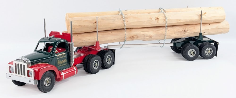 Fred Thompson Smith Miller Logging Company B Mack Log Hauler Truck: Fred Thompson Smith Miller Logging Company B Mack log hauler truck. The truck features a load of logs, B Mack cab, chains, and chrome features. The truck is in very good condition like new in the foam