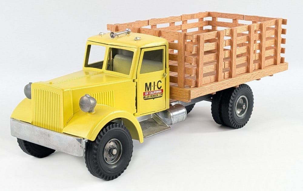 Custom Smith Miller MIC Stake Bed Truck: Custom Smith Miller MIC stake bed truck. The truck is painted in yellow with a custom wood stake bed. The passenger side door is missing the pin on the bottom hinge so it is a little loose. Overall di