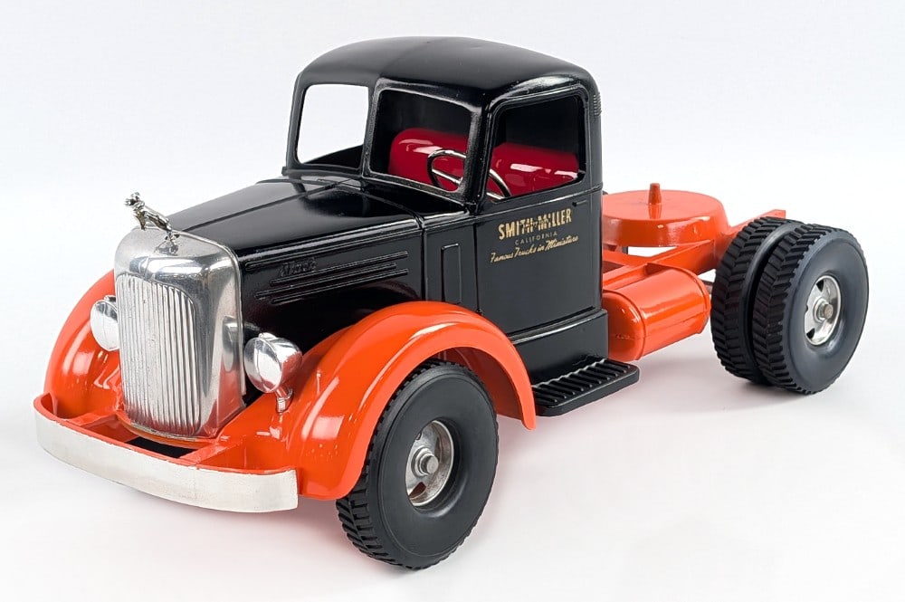 Custom Smith Miller L Mack Black and Orange Semi Truck: Custom Smith Miller L Mack black and orange semi truck. The truck has a replacement bumper, new bulldog hood ornament, and custom paint job. Good condition. Measures approximately 14" long.