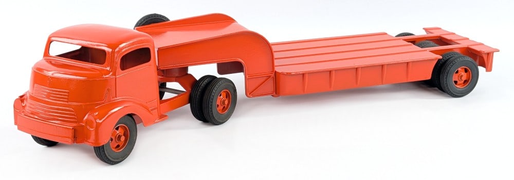 Custom Smith Miller GMC with Lowboy Trailer: Custom Smith Miller GMC truck with lowboy trailer. The truck is painted in orange overall with shortened front bumper and spare tire mounted on the trailer. The cab shows some dents and age wear. Meas