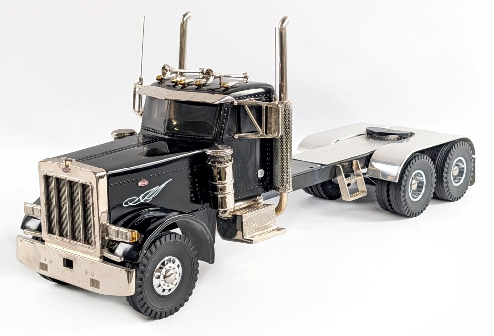 M&J Custom Peterbilt Semi Truck - Black: M&J custom Peterbilt semi truck in black. The truck shows some paint crazing and dust from being on display. The cab is resin with a metal frame and other metal parts. Overall a very nice detailed cus