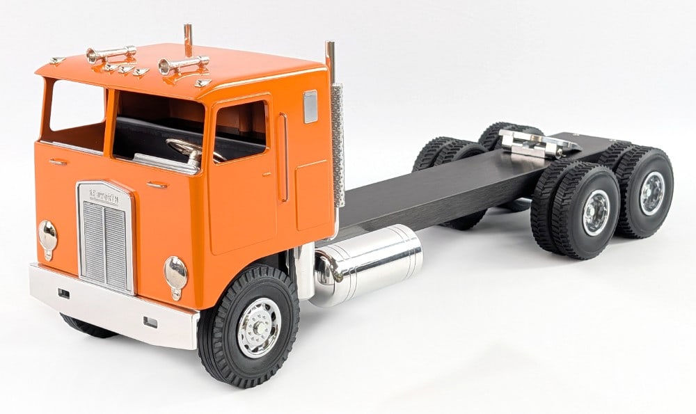 Custom Smith Miller Kenworth Cabover Semi Truck: Custom Smith Miller Kenworth cabover semi truck. The truck has a custom stretched frame, orange cab, custom wheels, and chrome features. Excellent condition and displays very well. Measures approximat