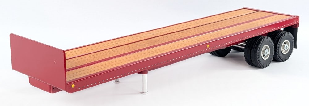 Custom Vern White Flatbed Trailer: Custom Vern White flatbed trailer. The trailer is painted in red with wood deck and reflectors. Good condition overall. Displays well with Smith Miller, All American, or other similar sized trucks.