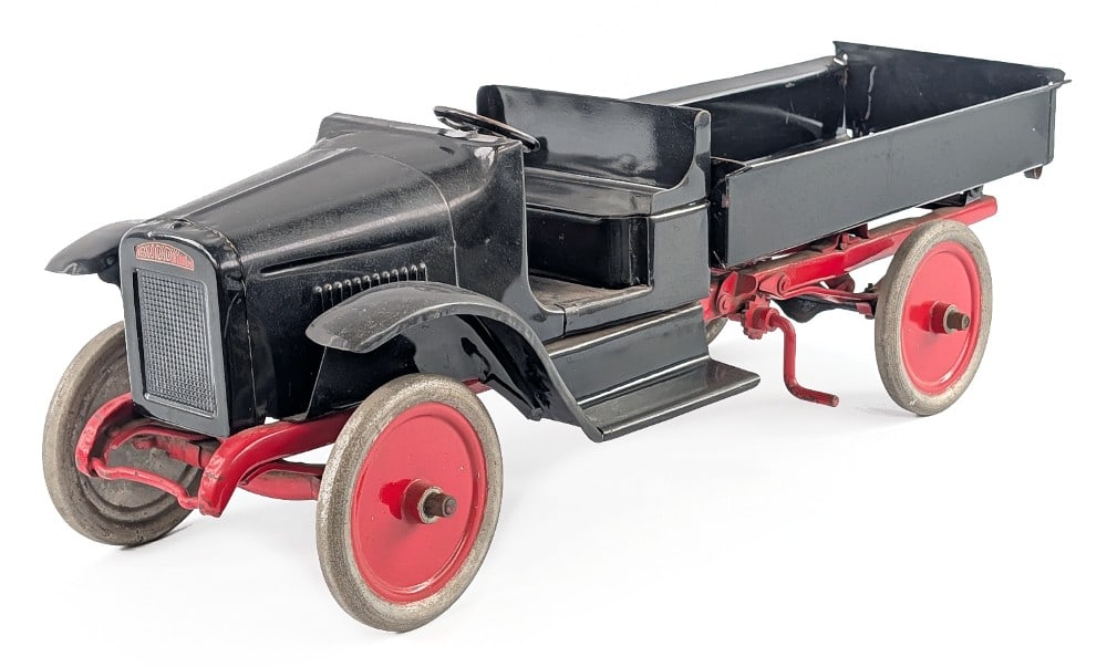 Restored Buddy L Chain Lift Dump Truck: Restored Buddy L chain lift dump truck. The truck has an older restoration and could use a good polishing. It has some scratches and dust from display. Measures approximatley 24" long.