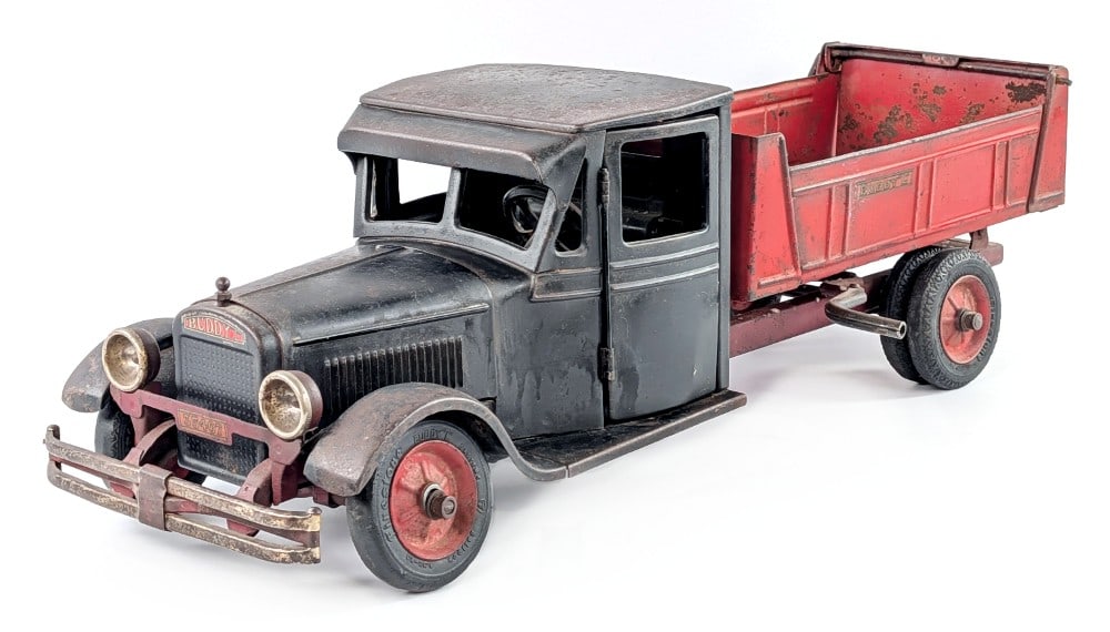Buddy L Junior Dump Truck: Buddy L Junior dump truck. The truck appears to be all original except for the radiator decal. The truck shows paint loss, surface rust, and wear from play and age. The truck may clean up to a higher 
