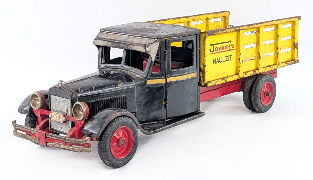 Buddy L Junior City Dray Truck: Buddy L Junior City Dray truck. The truck has an old period customization / overpaint. The yellow sides are marked "Johnny's Haulzit" The truck displays well overall with a good look. It was lightly c