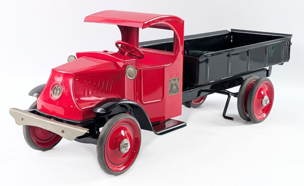 Restored Steelcraft Mack Dump Truck with Dual Wheels: Professionally restored Steelcraft Mack dump truck. A "C" cab style mack truck with dual rear wheels. A somewhat older restoration showing some oxidation to the bumper and headlight pods, but may clea