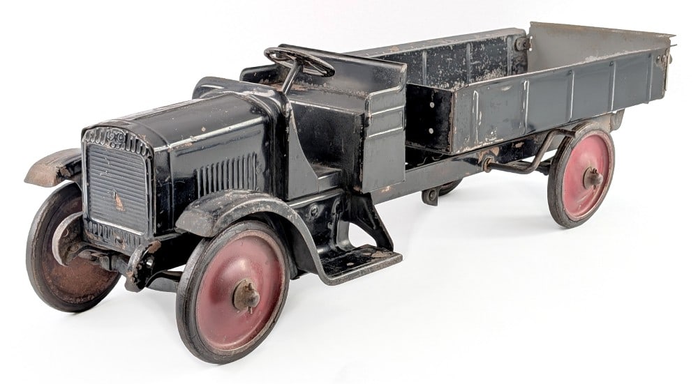 Steelcraft GMC Dump Truck: Steelcraft GMC dump truck. The truck is original except for the tailgate on the dump bed. The truck has paint loss and wear from play and age. Measures approximately 26" long.